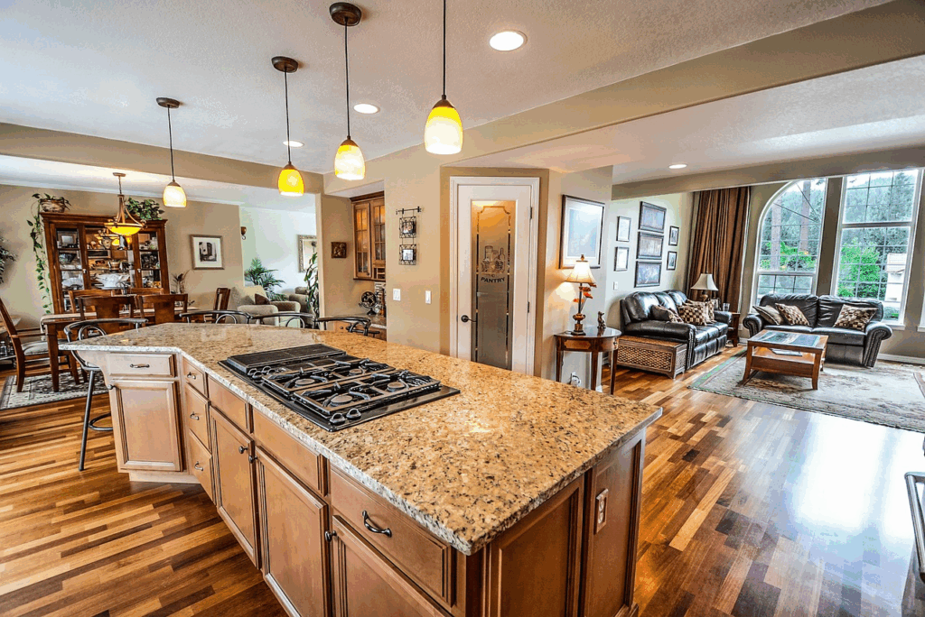 Updated open-concept kitchen with granite countertops and hardwood floors showcasing high-ROI home renovations.