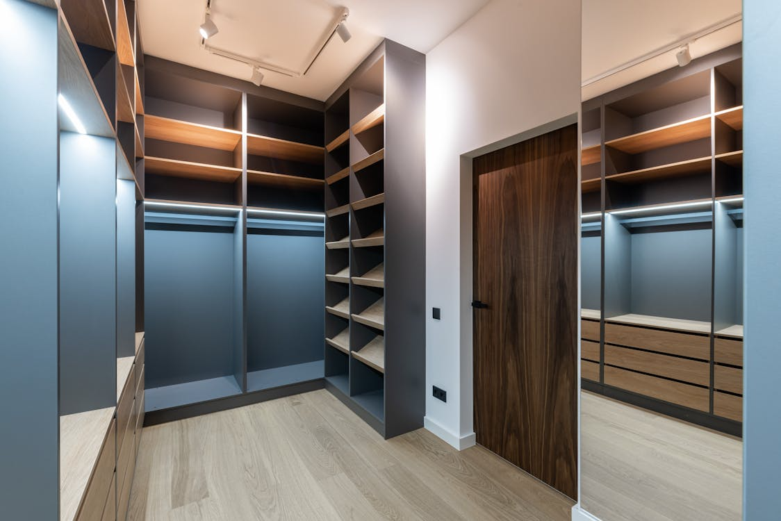 Custom walk-in closet with built-in shelving and drawers designed to maximize storage and function.